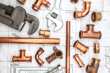 Picture of plumbing tools, pipes and fixtures.
